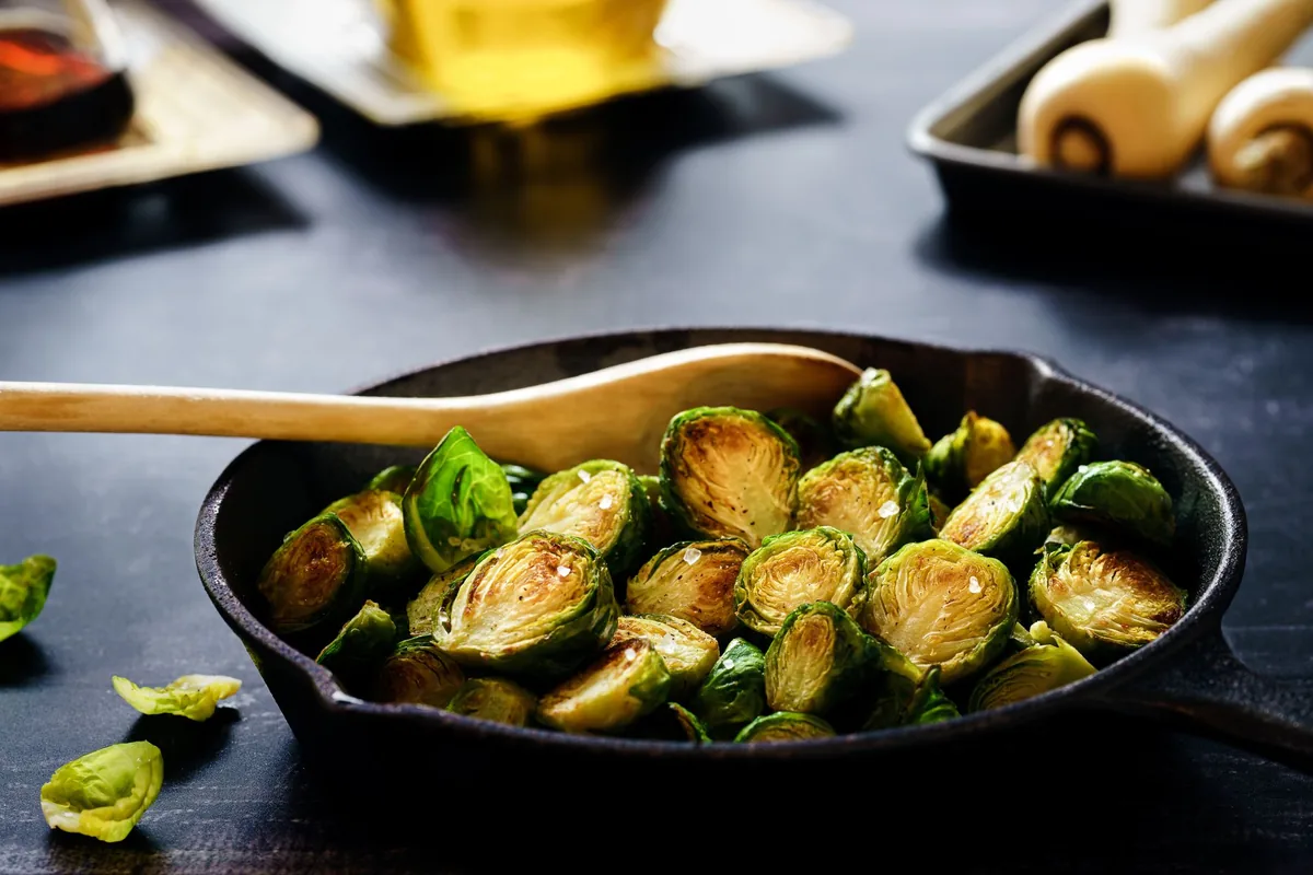 Halved Brussels sprouts roasted in a cast iron skillet