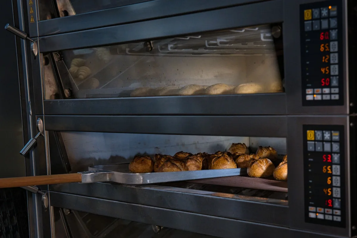 Bread rolls baking in a commercial deck oven