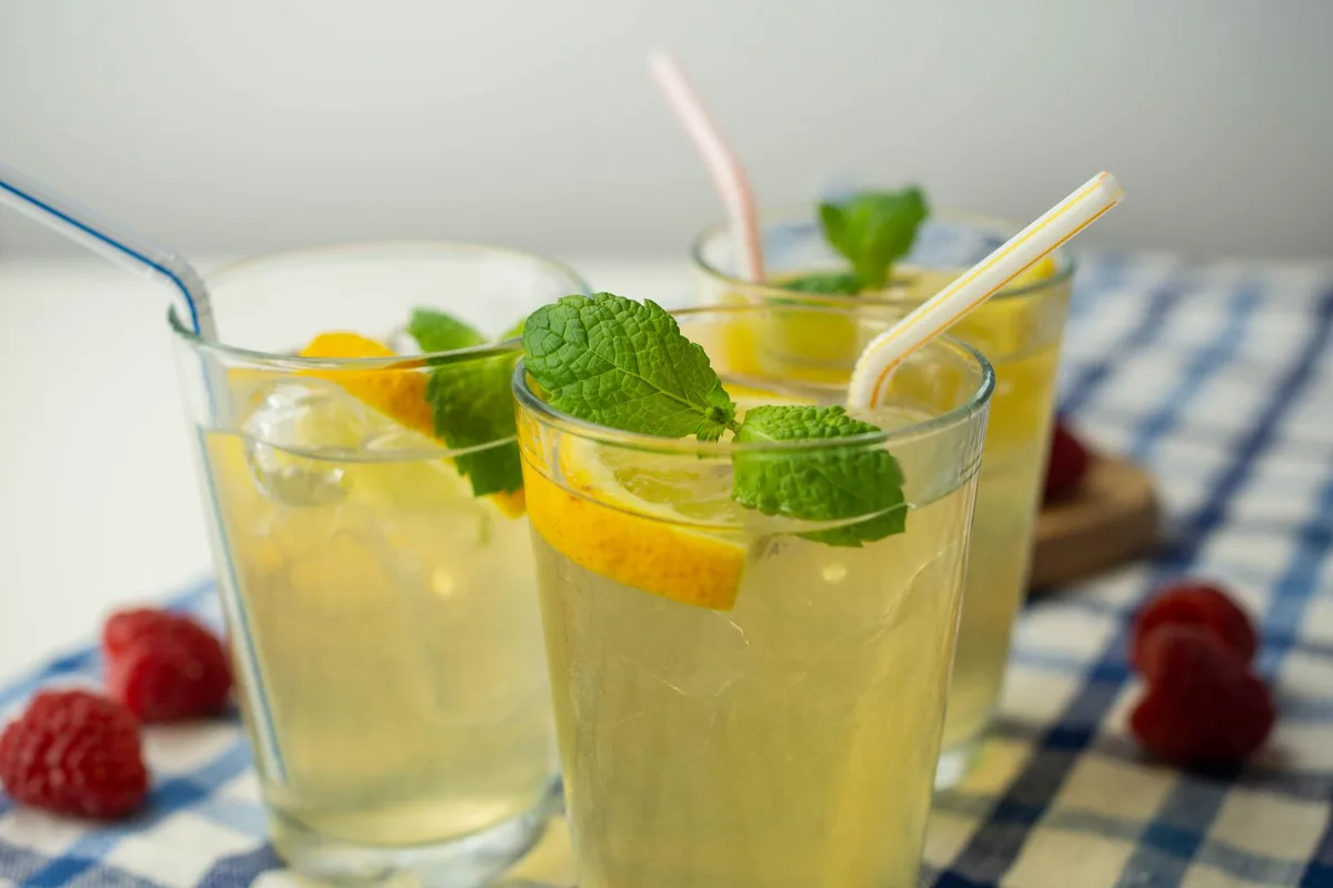 Two glasses of lemonade with mint and orange slices
