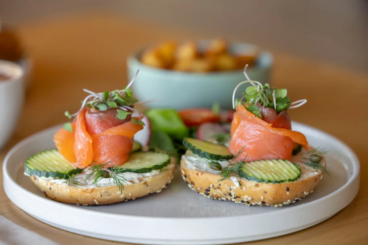 Bagel halves topped with smoked salmon and cucumber