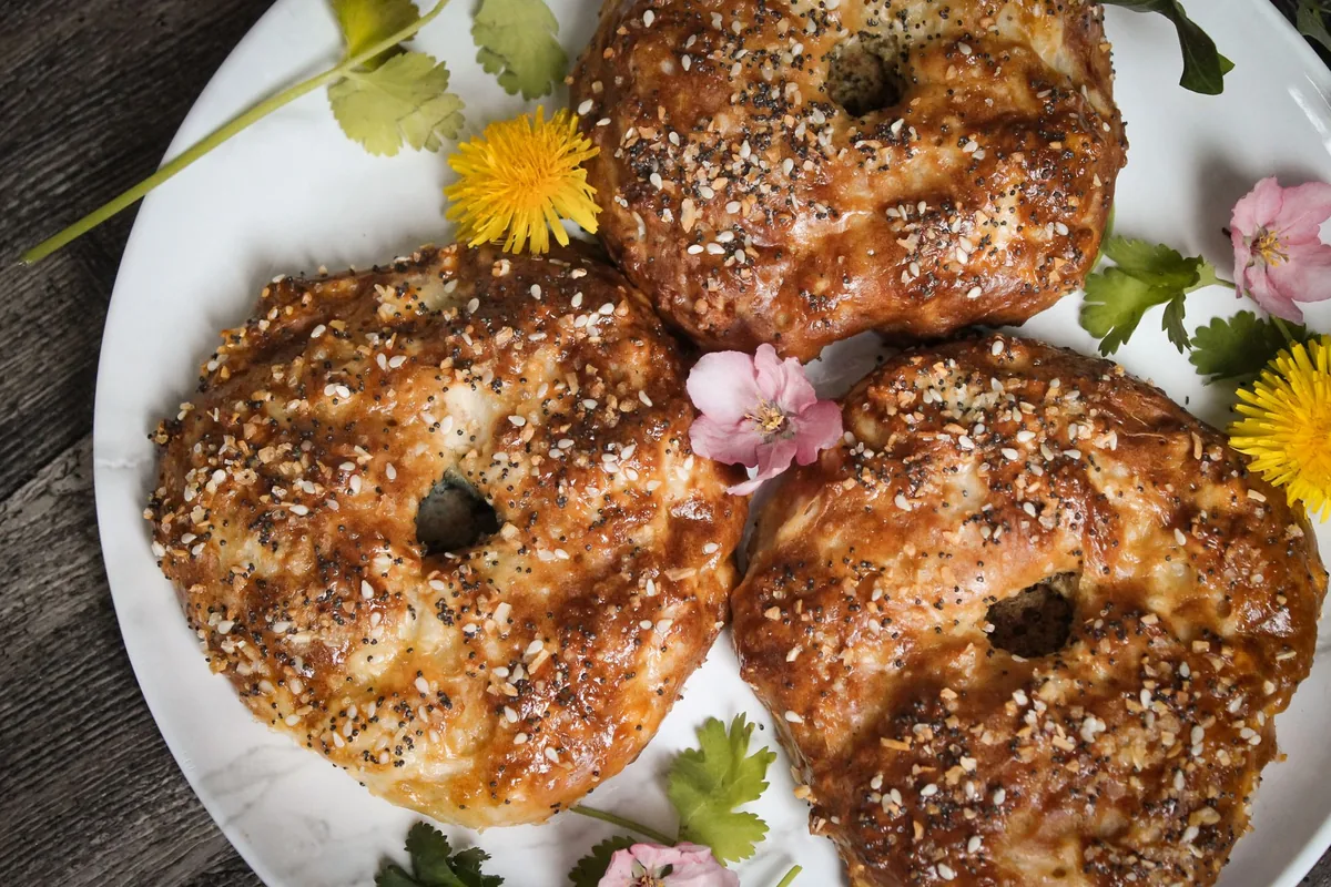 Seeded bagels on a plate with flowers
