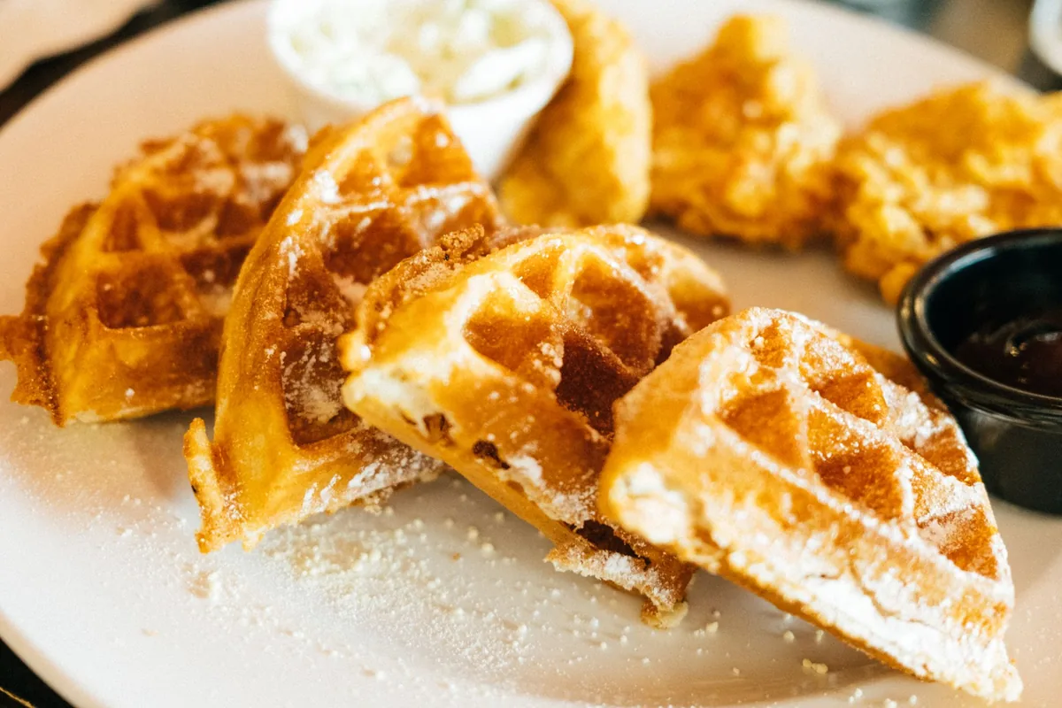 Waffle wedges dusted with sugar on a plate